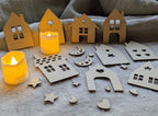 Kit calendrier de l'avent DIY bois brut : façades maisonnettes découpe laser avec fenêtres étoiles et cœurs, lunes et étoiles décoratives, bougies LED allumées